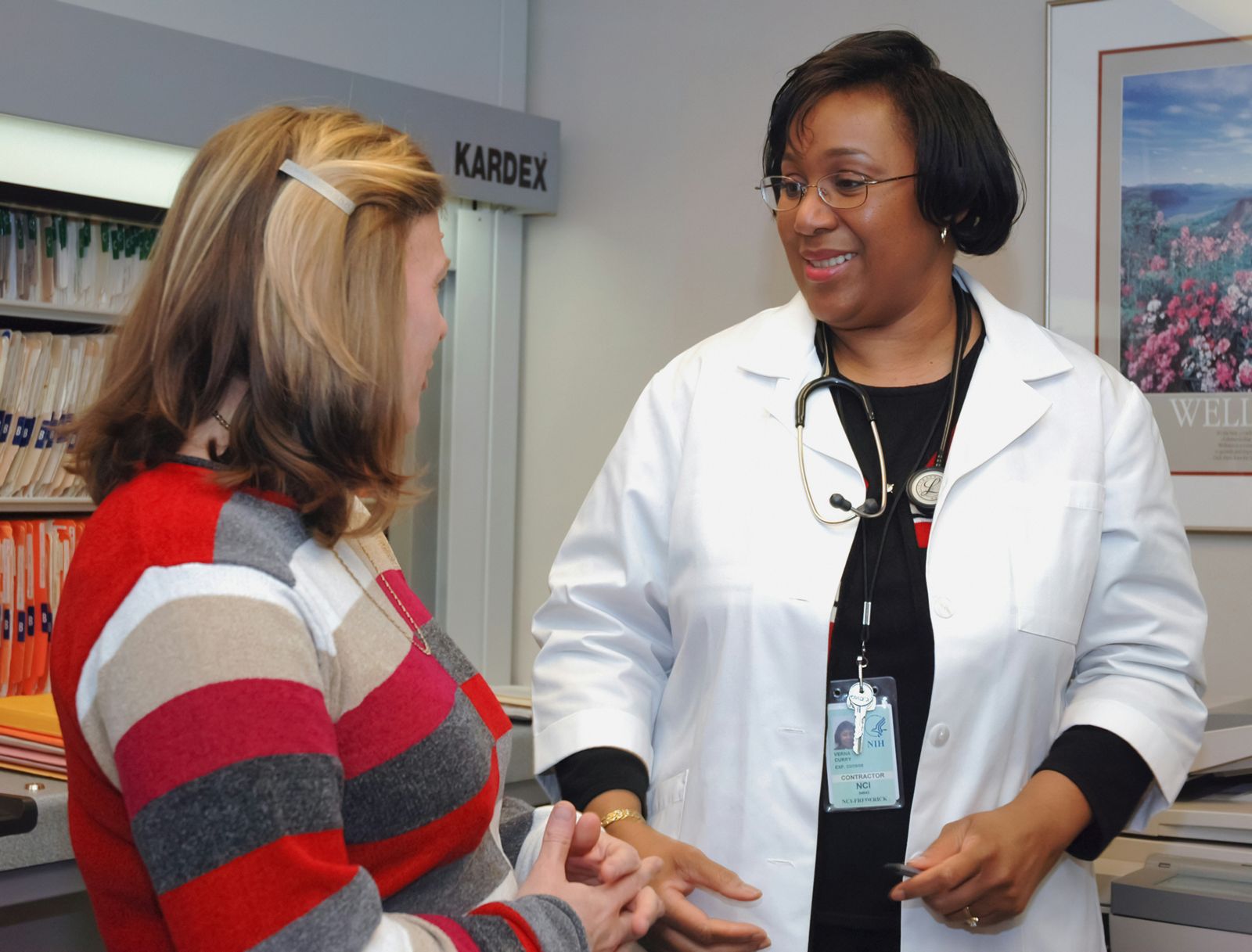 Healthcare provider with a stethoscope talks with a patient.